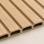 Close-up of a light wood-grain fluted WPC wall panel profile